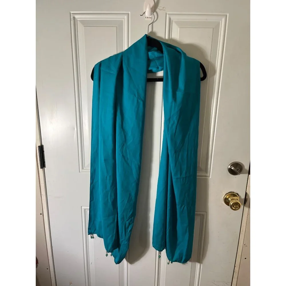 Teal colored shawl wrap with teal, silver, and gold beads on ends